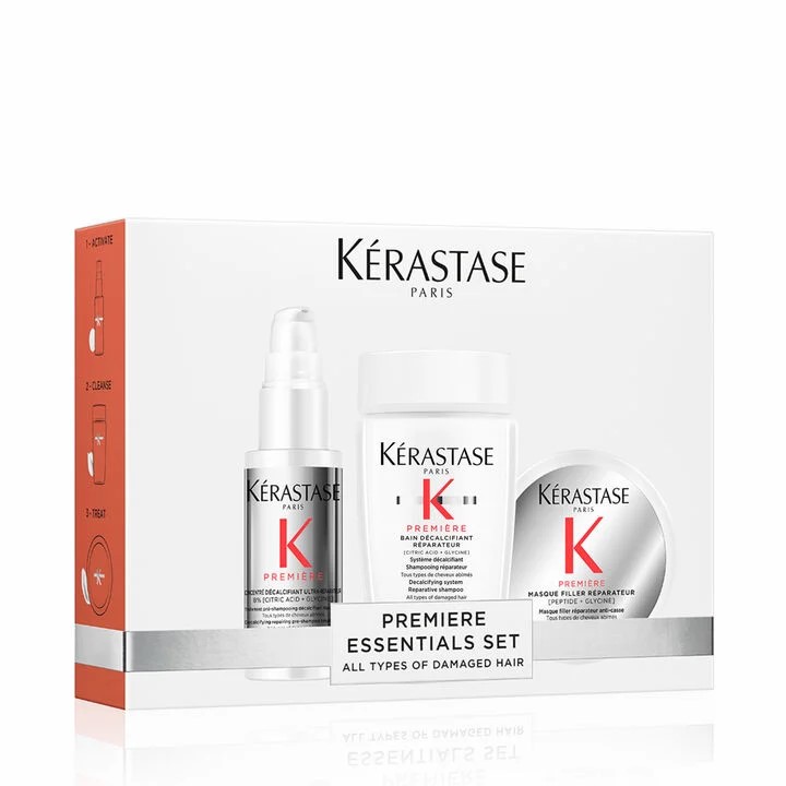 Kérastase Paris Première Essentials Set displayed in a white box, featuring a shampoo, repair serum, and hair mask for damaged hair, with clean minimalist packaging and red accents.